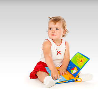 Little girl playing with book.